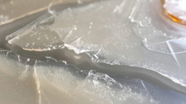 Close up of piece of plastic on top of white surface with.
