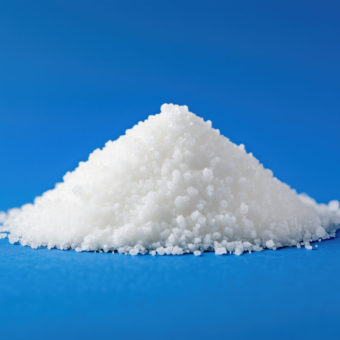Pile of white powder on a blue surface. The powder is white and he is salt